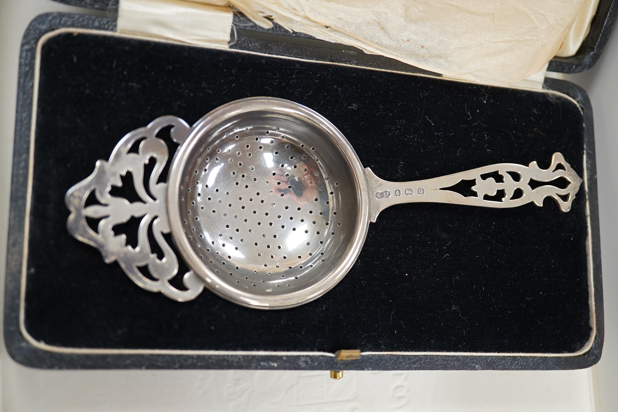 Sundry silver including a cigarette box (marks rubbed), 13.2cm, cased tea strainer, mounted wine coaster, small cup, match sleeve, card case, small case and 925 cylindrical box and cover. Condition - poor to fair to good